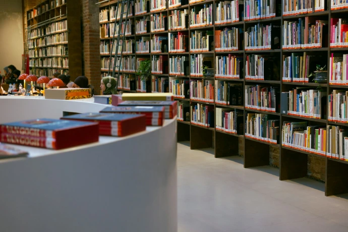A library filled with lots of books and people